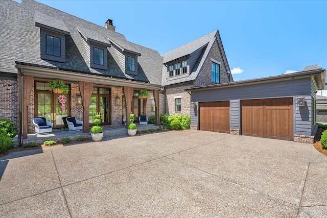 9289 Fordham Dr, Brentwood, TN 37027 - view of front of property featuring brick siding, driveway, a porch, a shingled roof, and a chimney