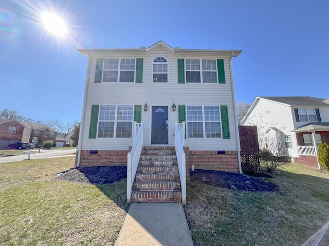 view of front of property featuring a front lawn and crawl space