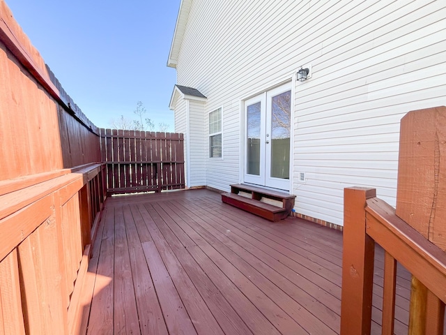 deck featuring french doors and fence