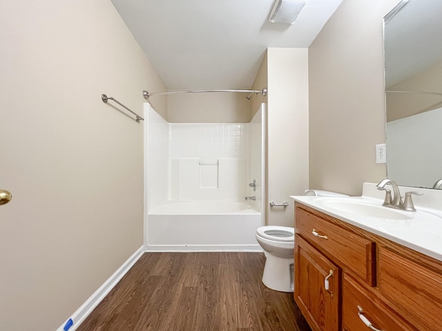 full bathroom featuring toilet, tub / shower combination, vanity, wood finished floors, and baseboards