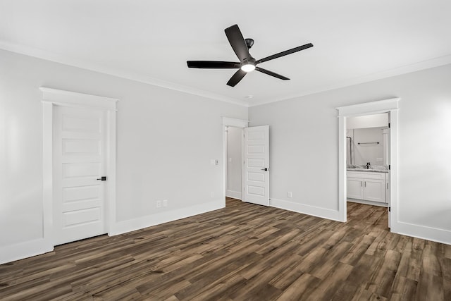 unfurnished bedroom with ceiling fan, ensuite bathroom, baseboards, dark wood finished floors, and crown molding