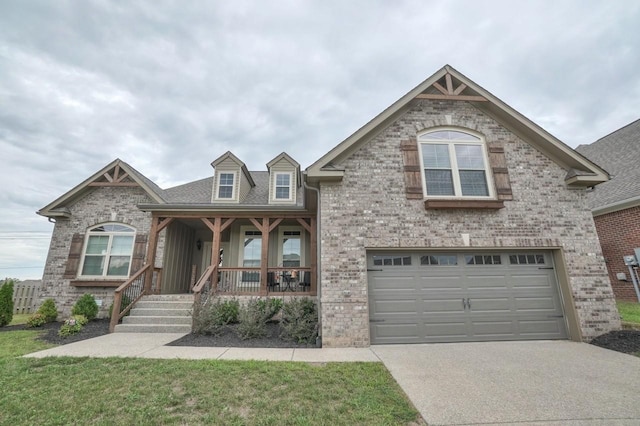 view of front of house featuring covered porch, brick siding, driveway, and an attached garage