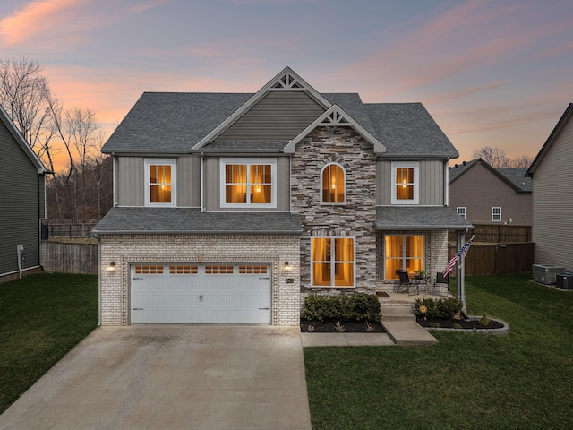 view of front of house with a garage, fence, a lawn, and concrete driveway