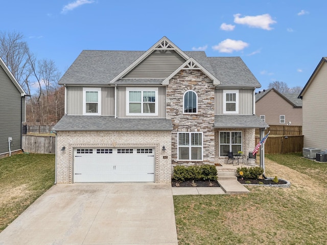 view of front of home with driveway, an attached garage, fence, a front lawn, and board and batten siding