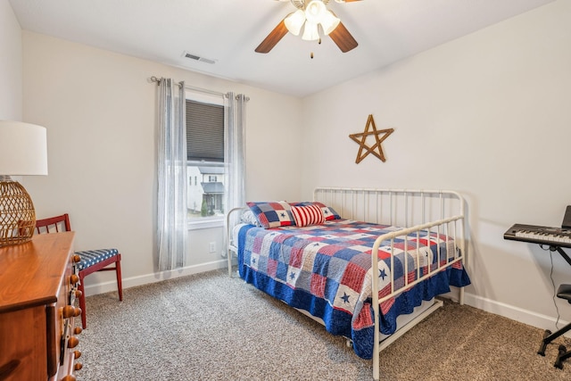 carpeted bedroom with baseboards, visible vents, and a ceiling fan