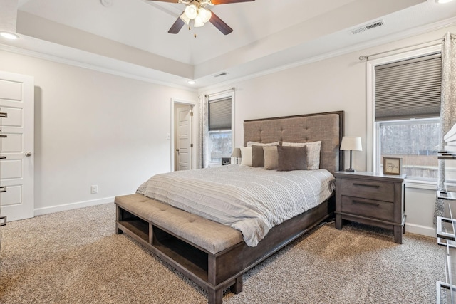 bedroom featuring carpet floors, baseboards, visible vents, and a raised ceiling