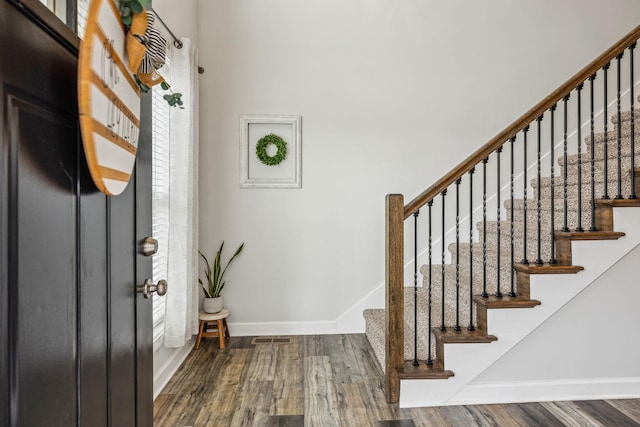 entrance foyer featuring wood finished floors, visible vents, and baseboards