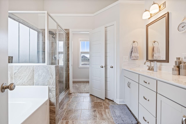 bathroom with a garden tub, ornamental molding, a stall shower, stone finish floor, and vanity