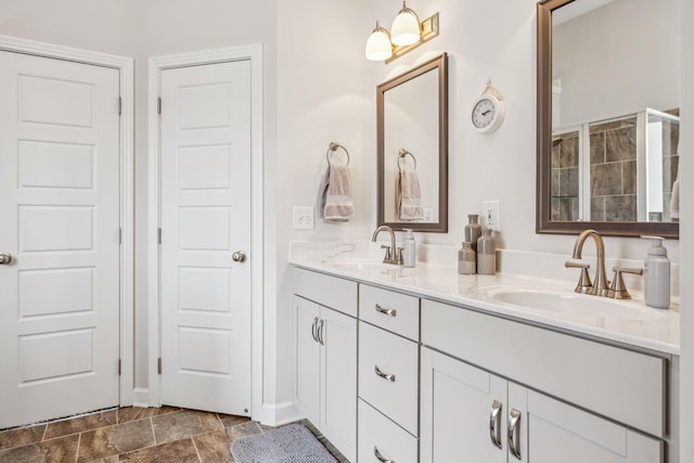 bathroom featuring a sink and double vanity