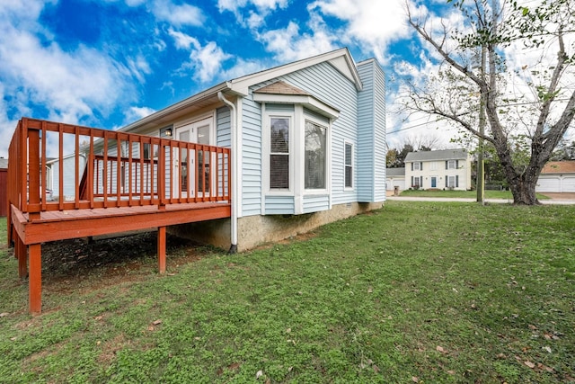 view of side of property featuring a yard, crawl space, and a wooden deck