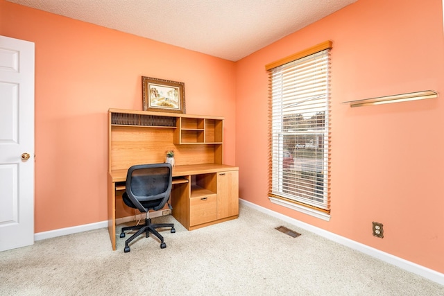 office area with baseboards, visible vents, a textured ceiling, and carpet flooring