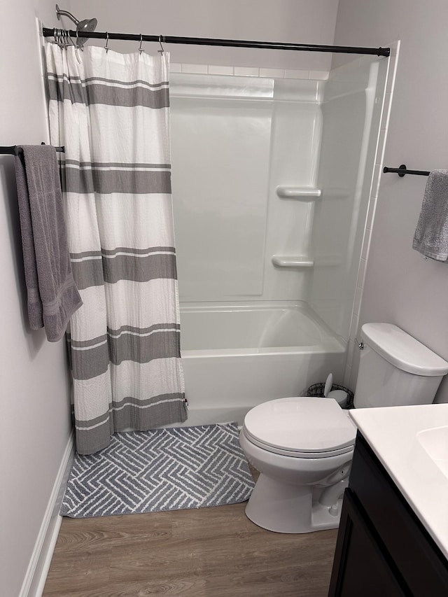 full bathroom featuring vanity, shower / bath combo with shower curtain, wood finished floors, and toilet