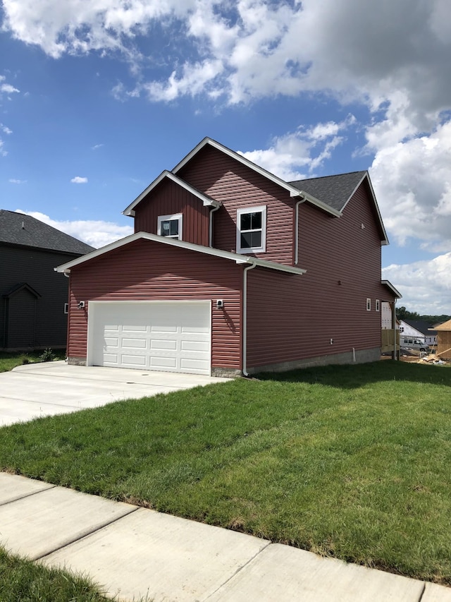 view of front of home with a garage, driveway, board and batten siding, and a front yard