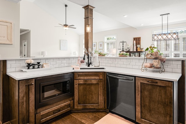 kitchen with light countertops, a sink, built in microwave, dishwasher, and a peninsula