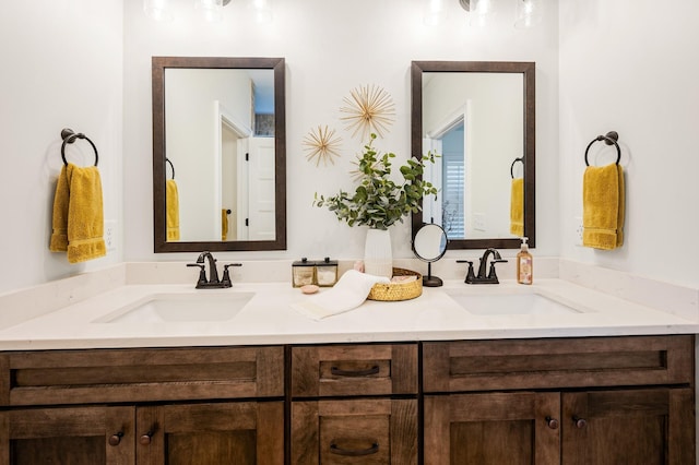 full bathroom featuring a sink and double vanity