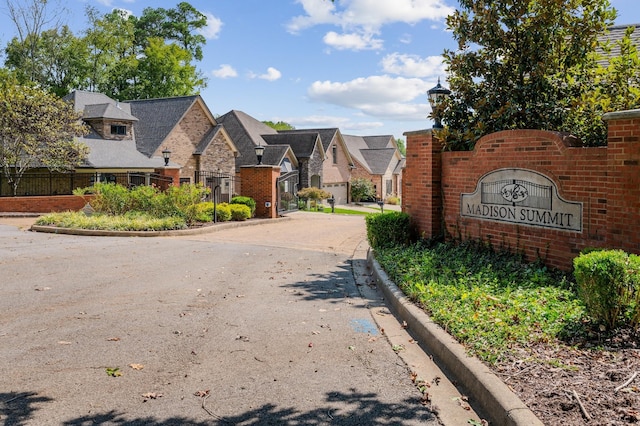 view of road featuring street lighting, a residential view, and curbs