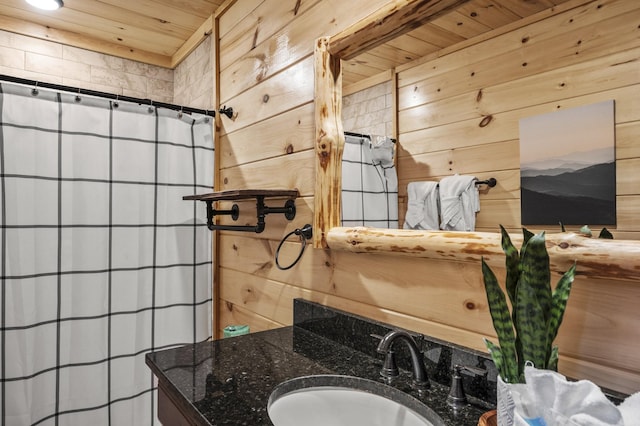 full bath with a shower with shower curtain, wooden ceiling, vanity, and wood walls