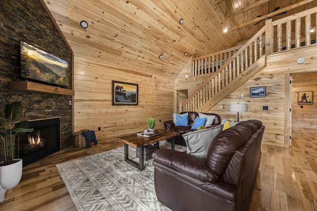 living room with high vaulted ceiling, wooden ceiling, a fireplace, and hardwood / wood-style floors