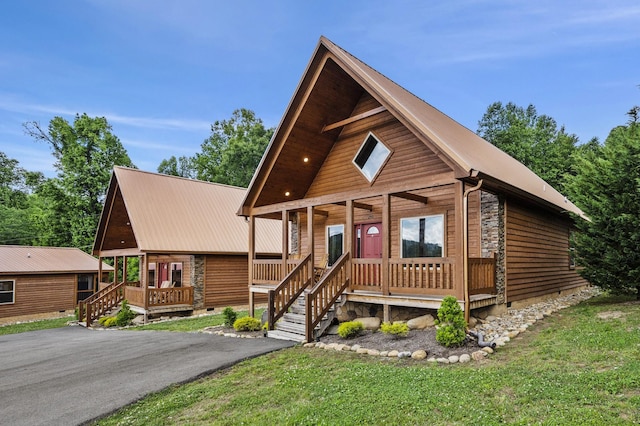 view of front of home featuring a front lawn, covered porch, metal roof, and crawl space