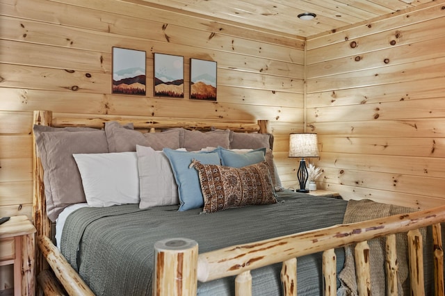 bedroom with wood walls and wood ceiling