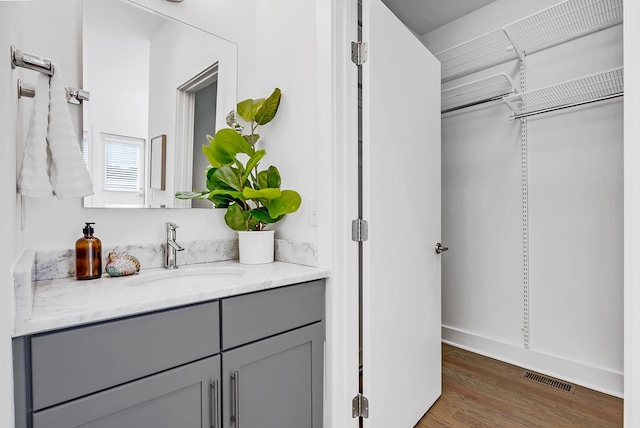 bathroom featuring visible vents, vanity, and wood finished floors