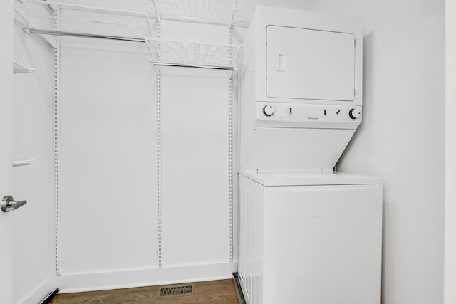 laundry room featuring stacked washer and dryer, laundry area, and visible vents