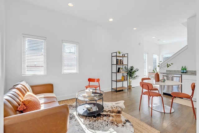 living room with light wood-type flooring, baseboards, and recessed lighting