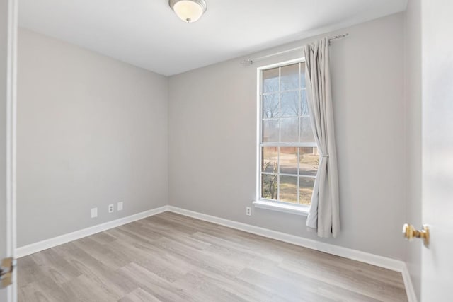 empty room featuring wood finished floors and baseboards