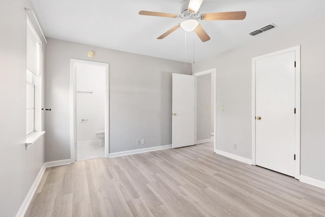 unfurnished bedroom with light wood-style flooring, visible vents, and baseboards