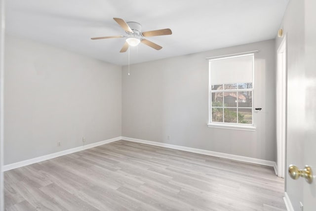 unfurnished room with a ceiling fan, light wood-style flooring, and baseboards