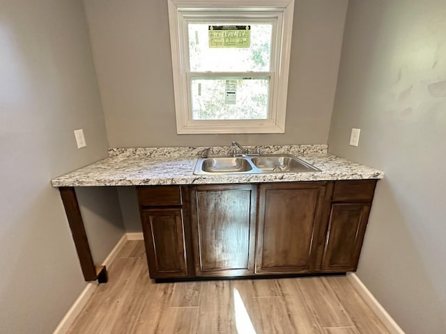 bathroom featuring wood finished floors, vanity, and baseboards