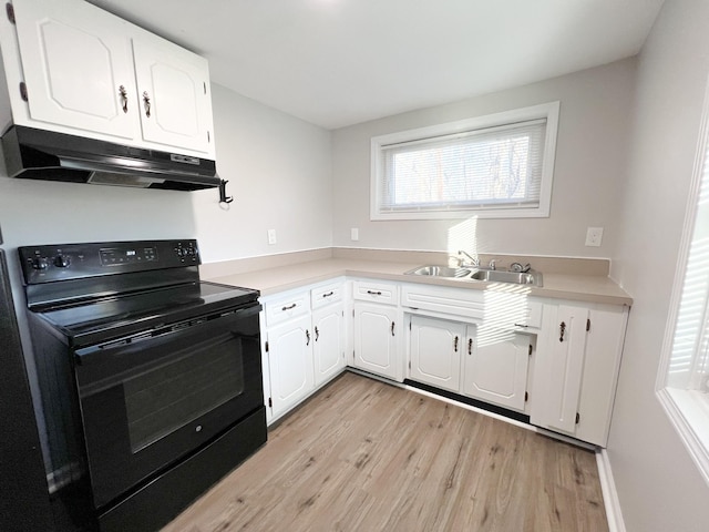 kitchen with black / electric stove, under cabinet range hood, a sink, white cabinetry, and light wood-style floors