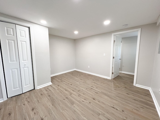 below grade area with light wood-type flooring, baseboards, and recessed lighting