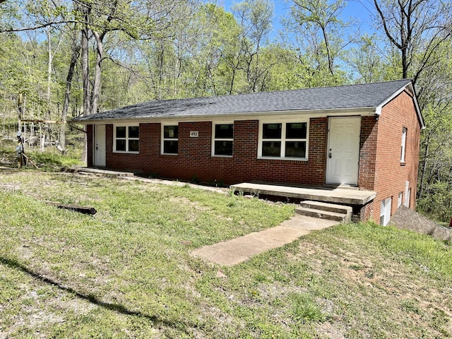 single story home featuring a front lawn, brick siding, and an attached garage