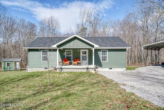 view of front of house featuring driveway, a storage unit, crawl space, and an outdoor structure