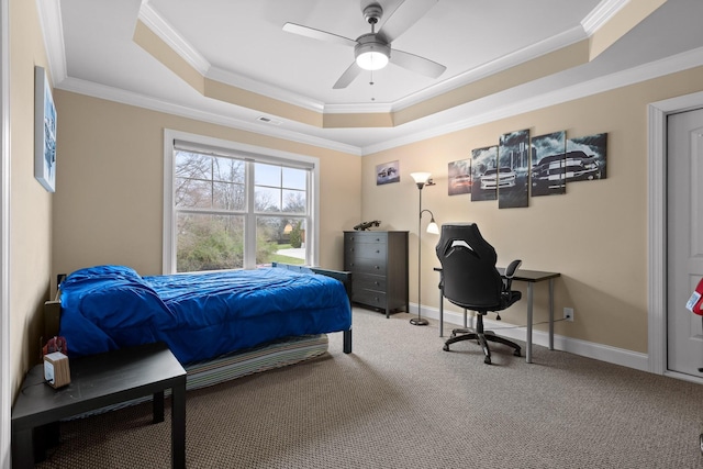 carpeted bedroom featuring ceiling fan, visible vents, baseboards, ornamental molding, and a raised ceiling