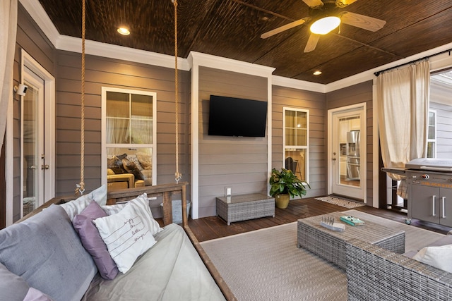 living room featuring wooden walls, wood ceiling, wood finished floors, crown molding, and recessed lighting