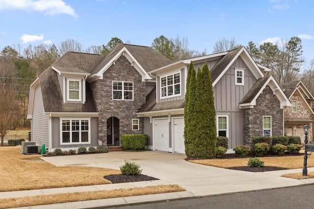 craftsman inspired home with an attached garage, cooling unit, stone siding, concrete driveway, and board and batten siding