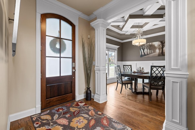 foyer with coffered ceiling, ornamental molding, dark wood-type flooring, beamed ceiling, and ornate columns