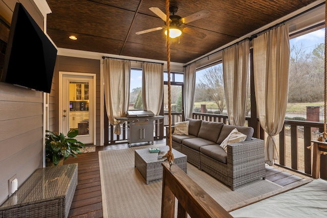 sunroom / solarium featuring wooden ceiling and ceiling fan