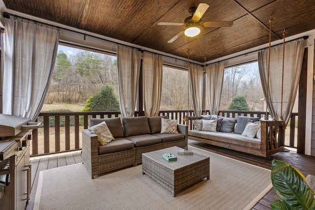 sunroom / solarium featuring ceiling fan and wooden ceiling