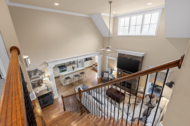 stairway with ceiling fan, recessed lighting, crown molding, and wood finished floors