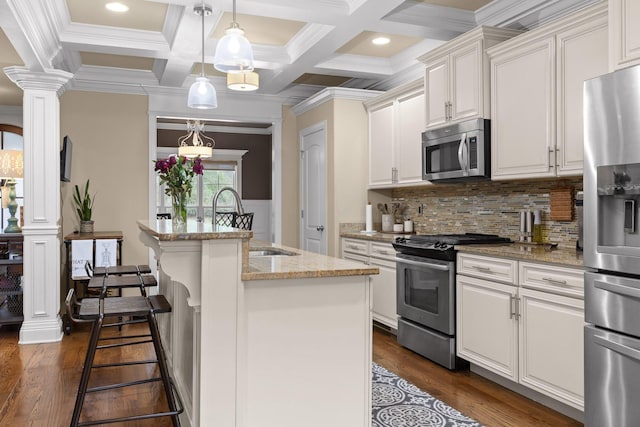 kitchen with white cabinetry, decorative columns, dark wood-style floors, and appliances with stainless steel finishes