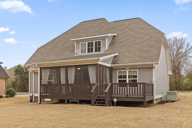 rear view of property featuring a sunroom, roof with shingles, crawl space, a yard, and central air condition unit