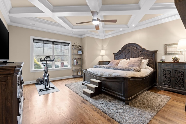 bedroom with light wood-style floors, ornamental molding, a ceiling fan, coffered ceiling, and baseboards