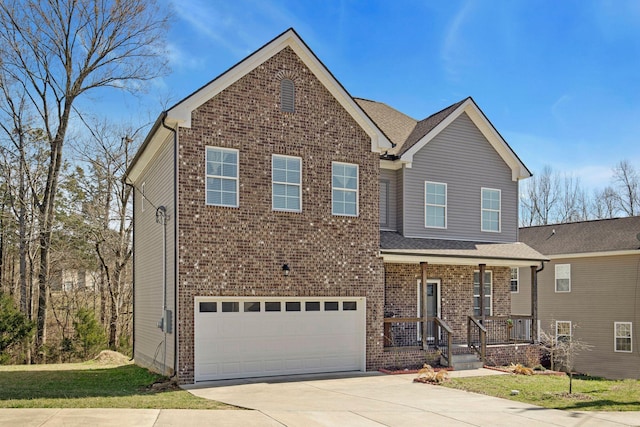 traditional-style home featuring brick siding, a porch, concrete driveway, a front yard, and a garage