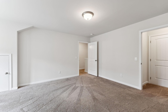 unfurnished bedroom featuring carpet and baseboards