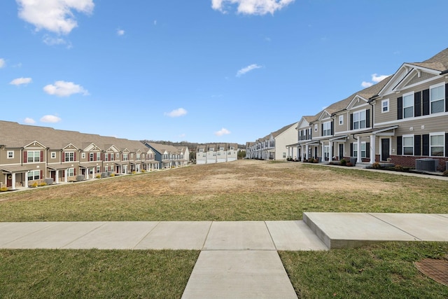 surrounding community with a yard and a residential view