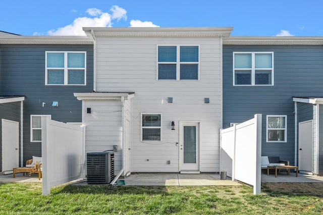 back of house featuring a yard, fence, central AC unit, and a patio