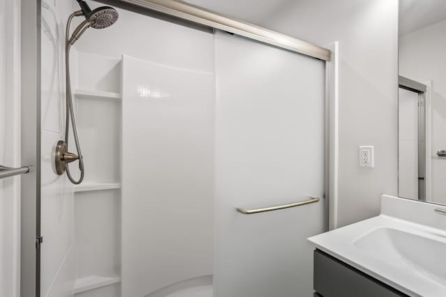 full bath with a shower stall and vanity